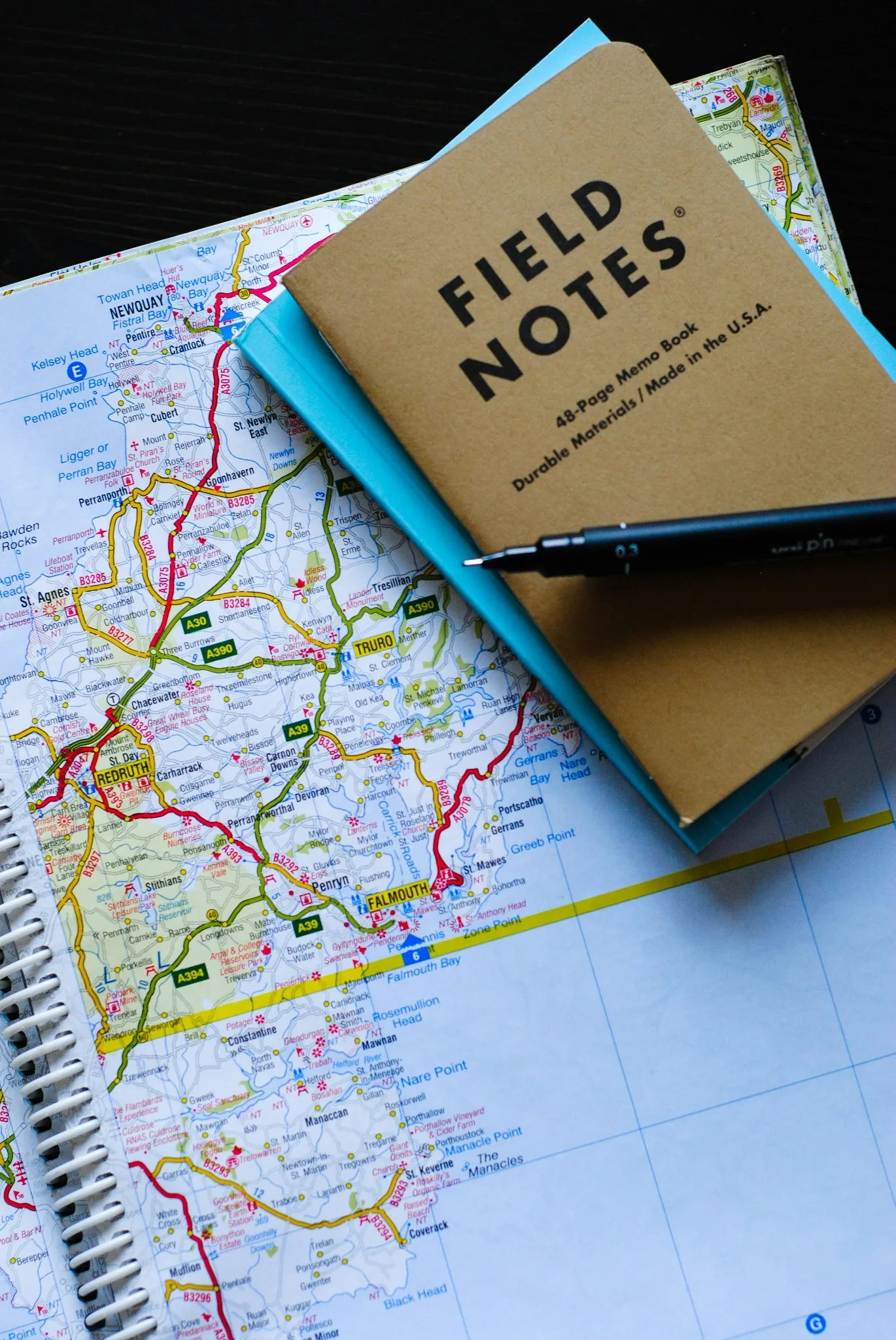 An open notebook labelled Paris Notes, with a pen and a map