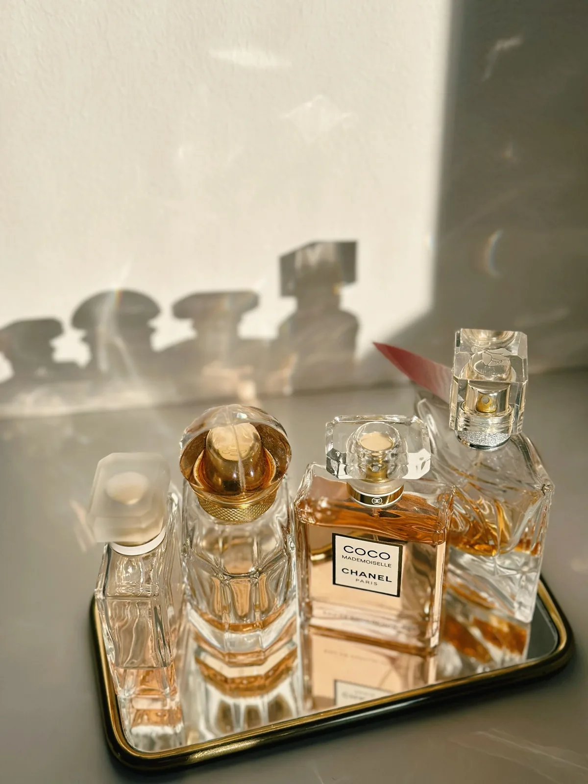 Perfume bottles on a mirrored tray