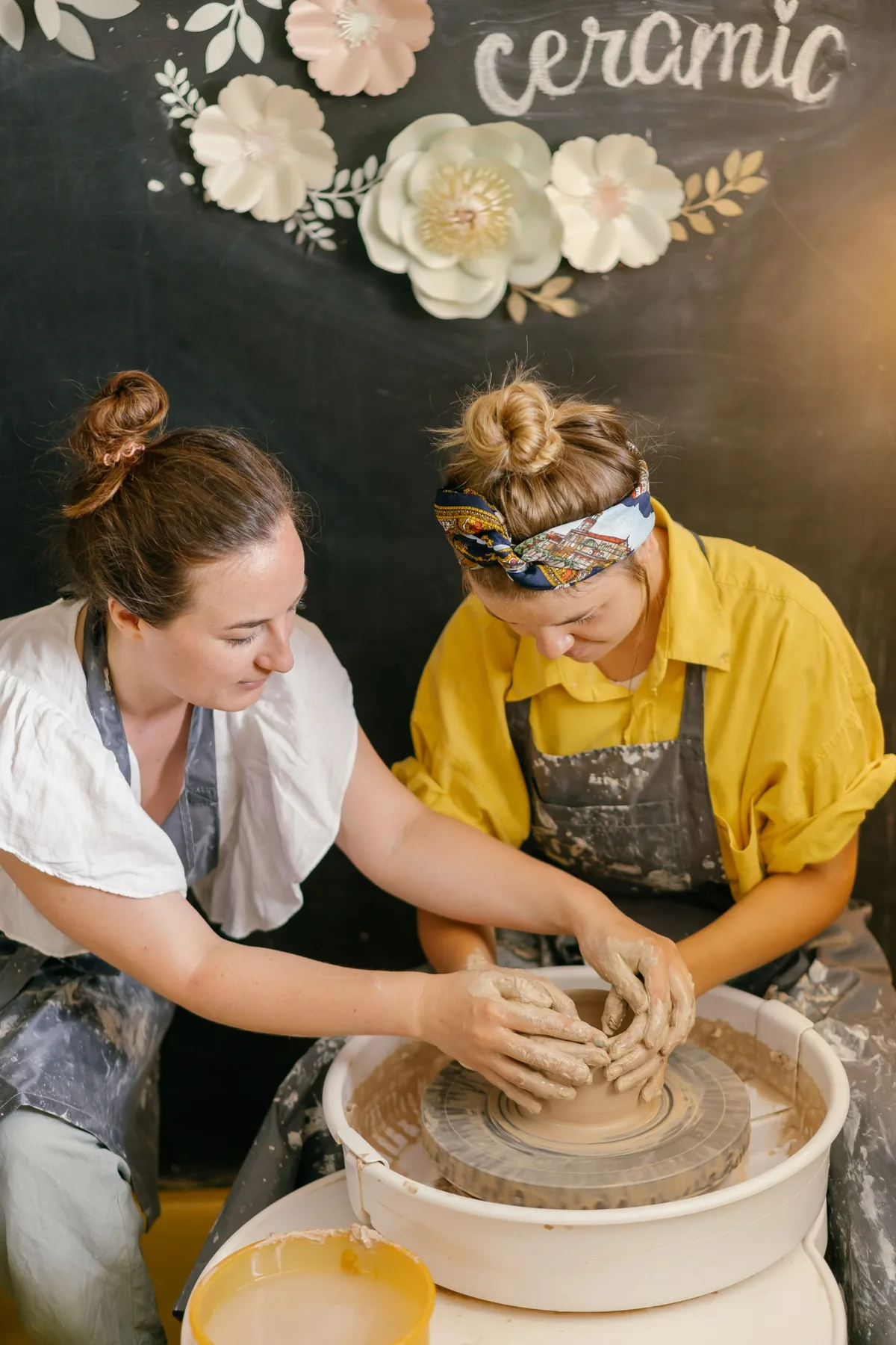 Two people at a pottery wheel