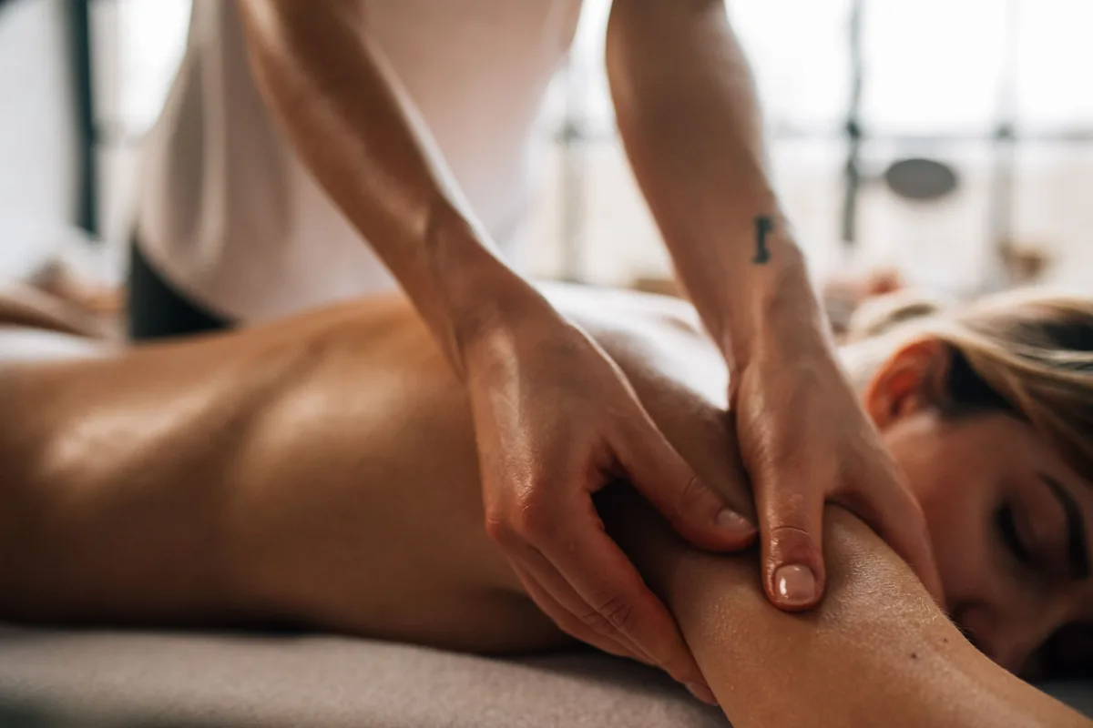 A person receiving a shoulder massage