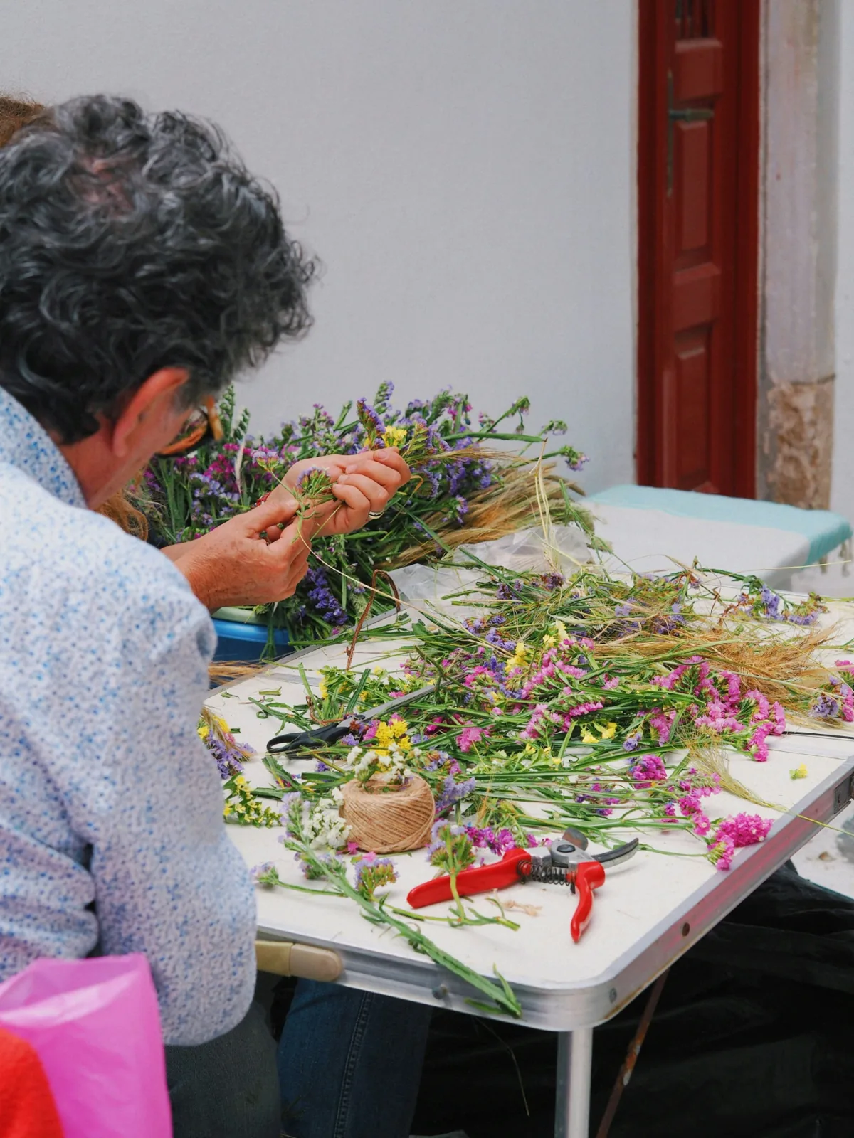 People arranging fresh flowers at a workshop