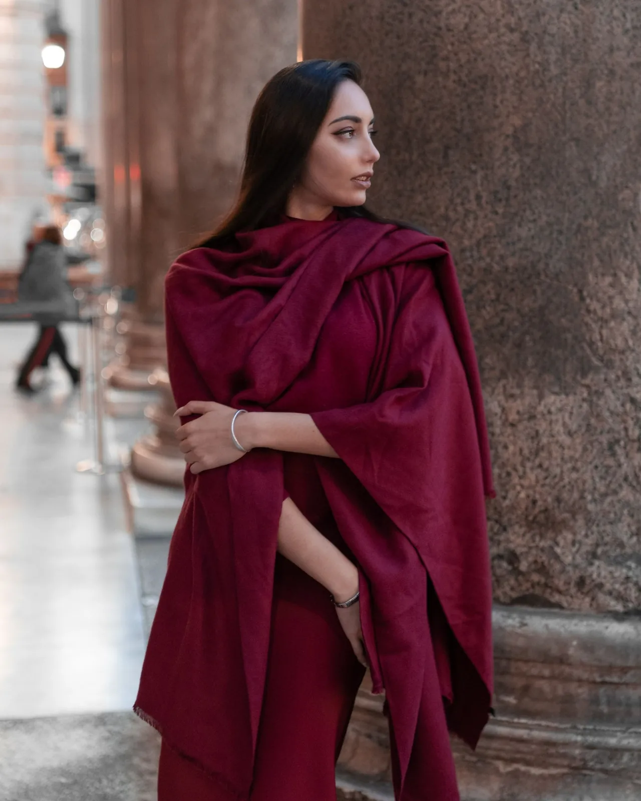 A burgundy wrap draped for display. The photograph does not confirm that the fibre is wool.