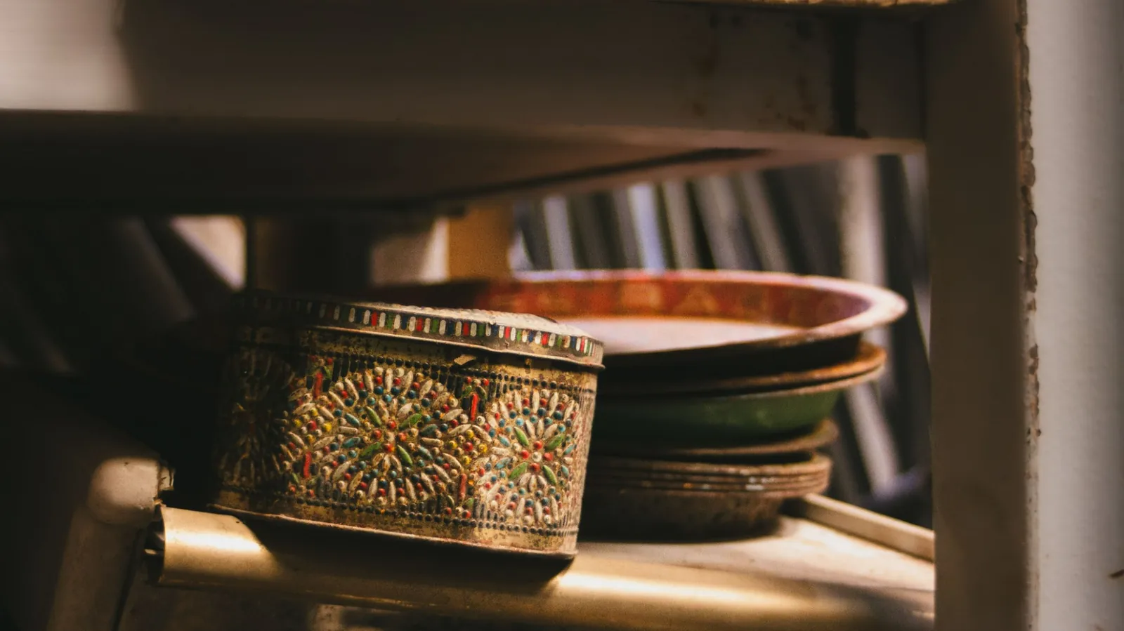 A decorative vintage metal tin. The photograph does not confirm that the metal is tin.
