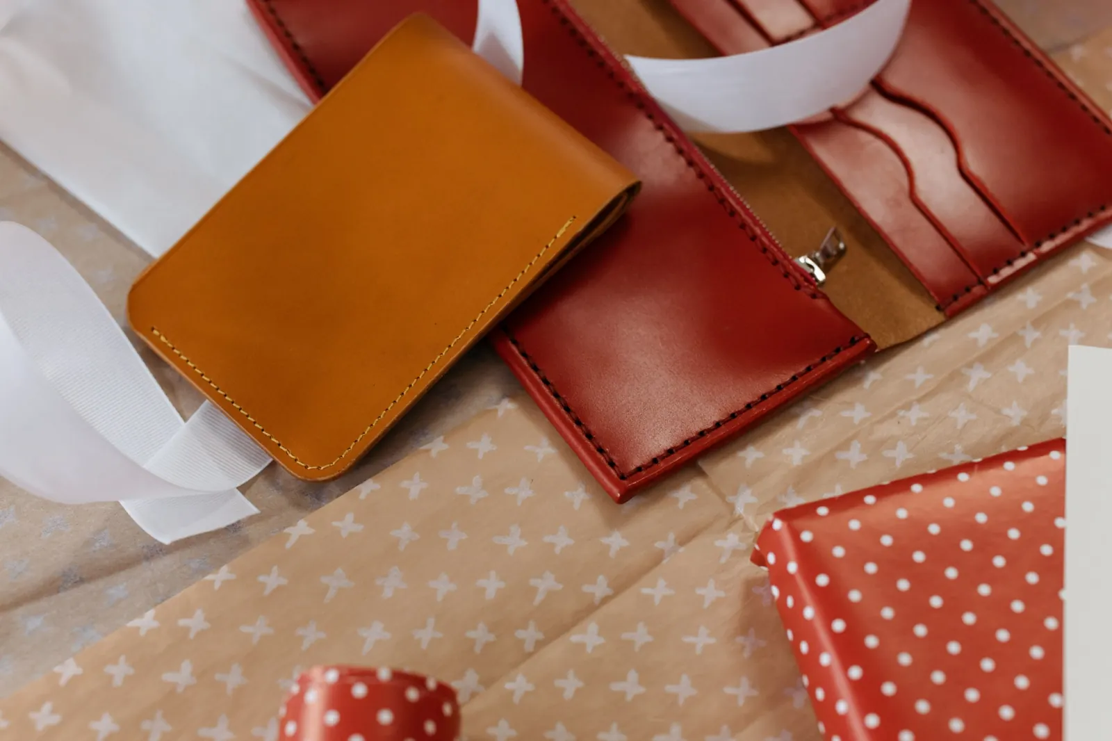 Leather wallets arranged with gift wrapping materials