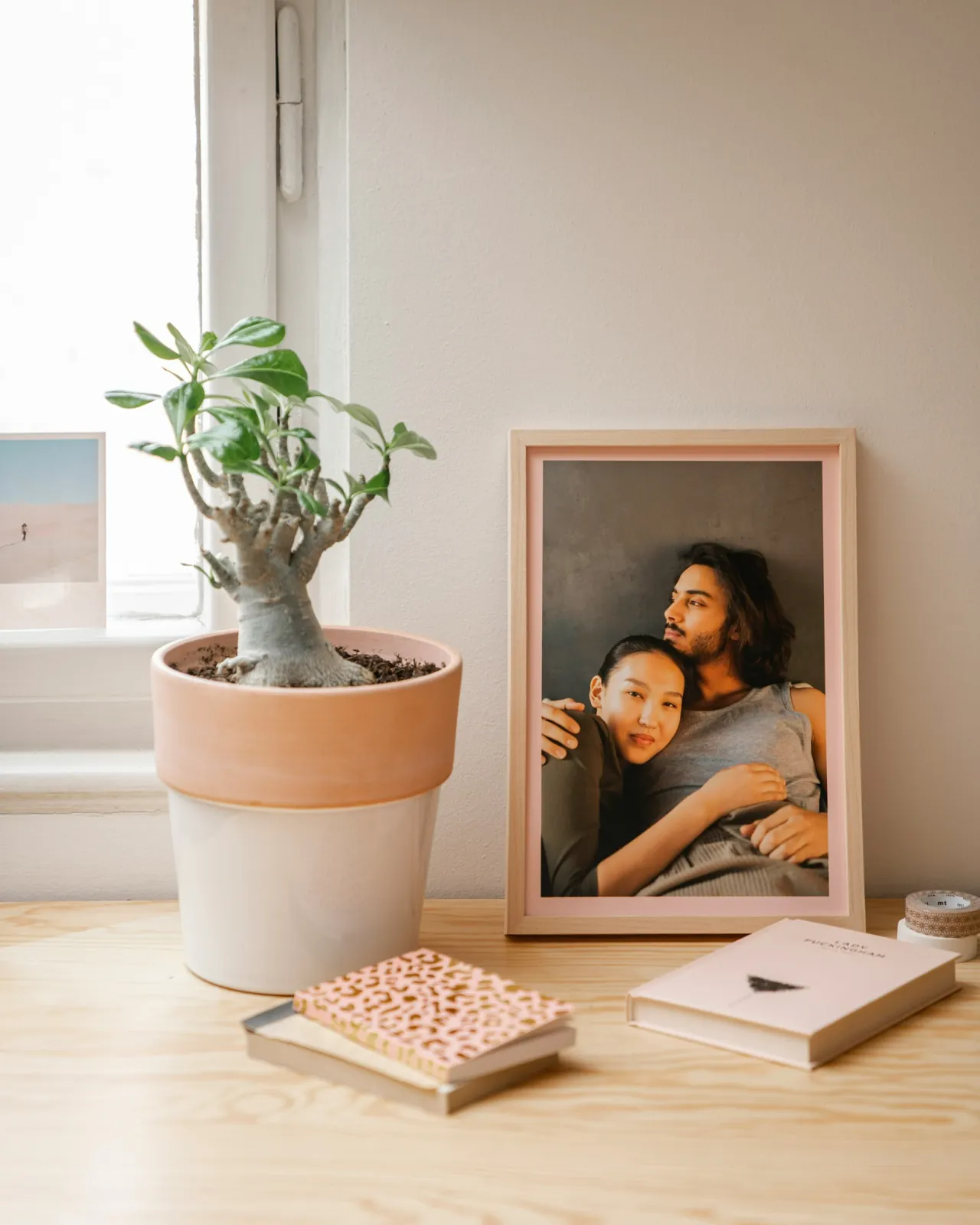 Framed photograph of a couple on a wooden shelf